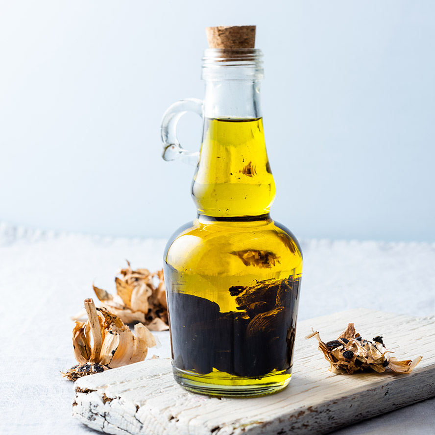 Olive oil bottle on wooden board